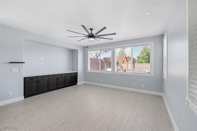 spare room featuring ceiling fan and light hardwood / wood-style floors