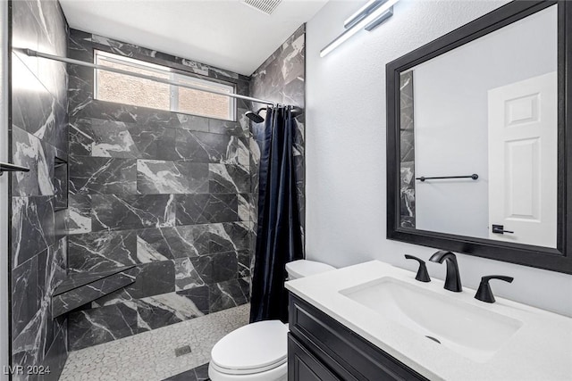 bathroom with toilet, vanity, and a shower with shower curtain