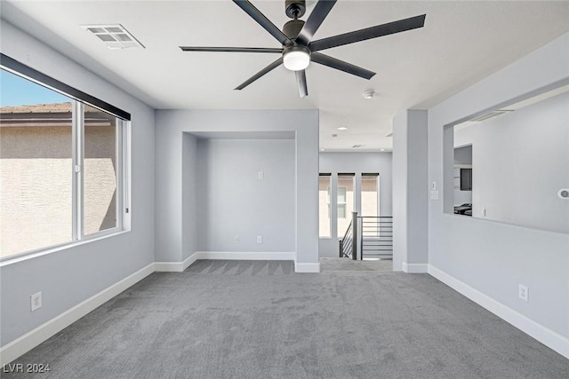 carpeted empty room featuring ceiling fan