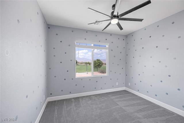 spare room featuring carpet floors and ceiling fan