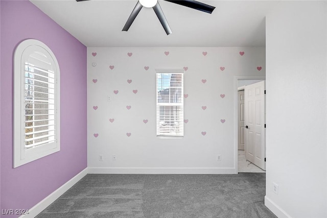 empty room with carpet flooring and ceiling fan