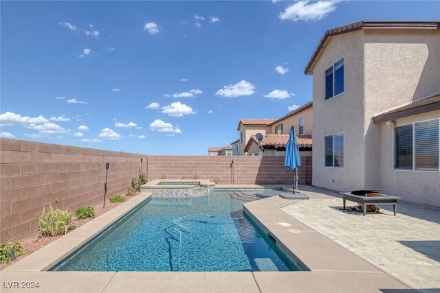 view of pool with an in ground hot tub and a patio