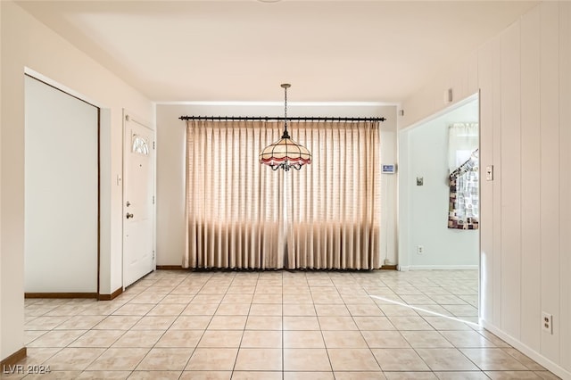 unfurnished dining area featuring light tile patterned floors