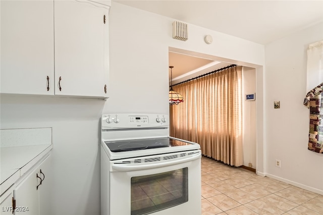 kitchen featuring electric range, white cabinetry, hanging light fixtures, and light tile patterned floors