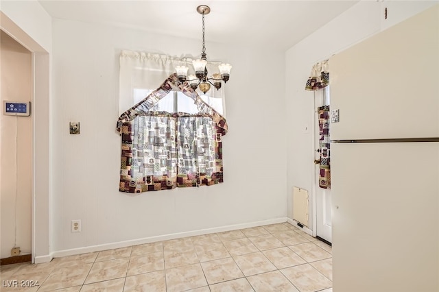 unfurnished dining area featuring light tile patterned floors and a notable chandelier