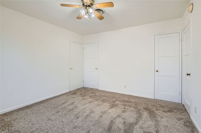 spare room featuring carpet and ceiling fan