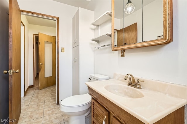 bathroom featuring tile patterned floors, vanity, and toilet