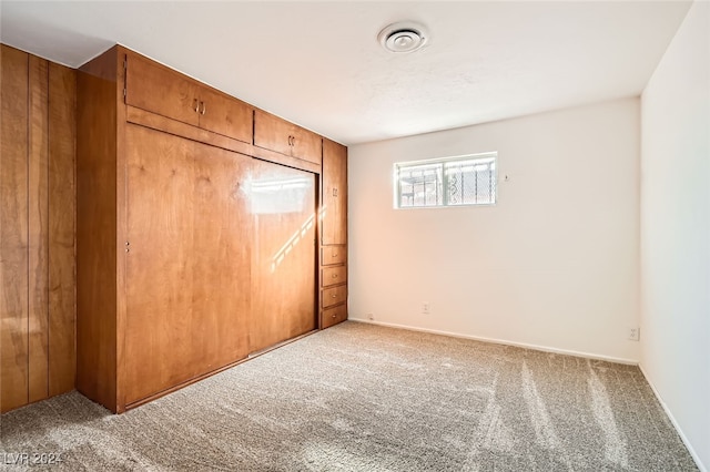 unfurnished bedroom featuring a closet and carpet floors