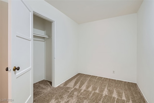 unfurnished bedroom with carpet and a closet