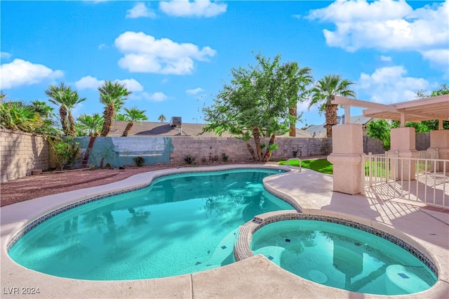 view of swimming pool featuring a patio and an in ground hot tub