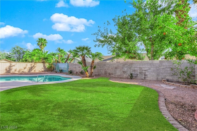 view of yard with a fenced in pool