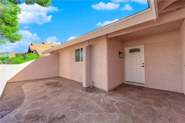 property entrance featuring a patio area