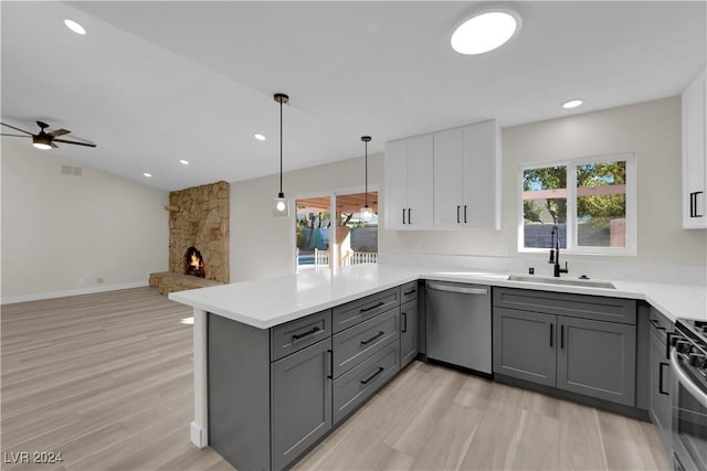 kitchen featuring kitchen peninsula, appliances with stainless steel finishes, gray cabinets, and sink