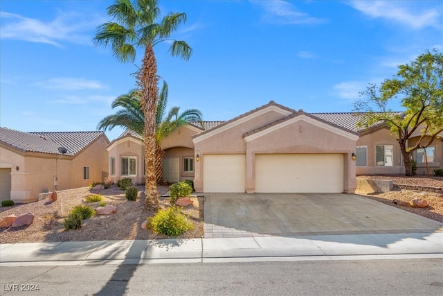 mediterranean / spanish-style home with a garage