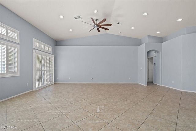 unfurnished room featuring ceiling fan, light tile patterned floors, and vaulted ceiling