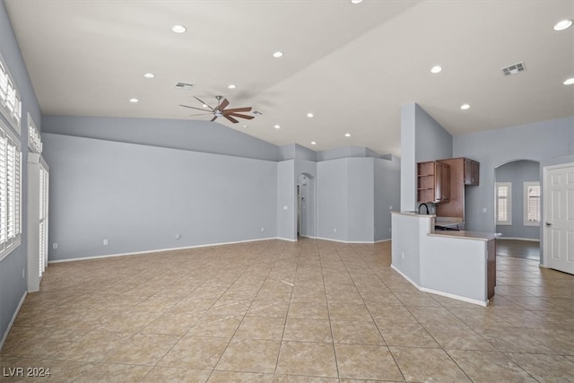 interior space featuring vaulted ceiling, light tile patterned floors, and ceiling fan