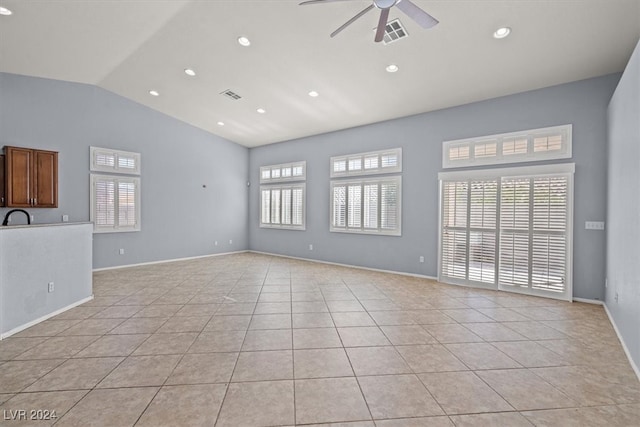 unfurnished living room with light tile patterned flooring, ceiling fan, and vaulted ceiling