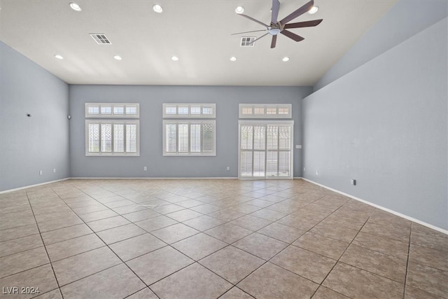 tiled spare room featuring ceiling fan and vaulted ceiling