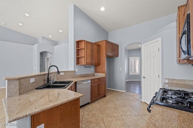 kitchen with vaulted ceiling, sink, black appliances, and kitchen peninsula