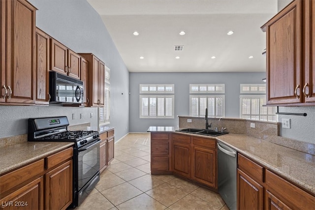 kitchen featuring black appliances, light stone counters, light tile patterned floors, sink, and vaulted ceiling