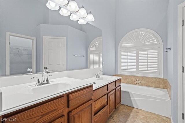 bathroom with vanity, tile patterned floors, and a bath