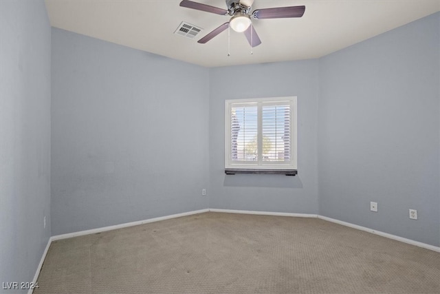 spare room featuring light carpet and ceiling fan