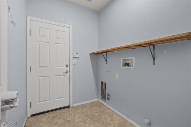 laundry room with washer hookup and light tile patterned floors