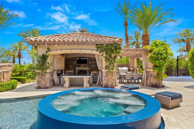 view of pool featuring exterior fireplace, a patio, a jacuzzi, and a pergola