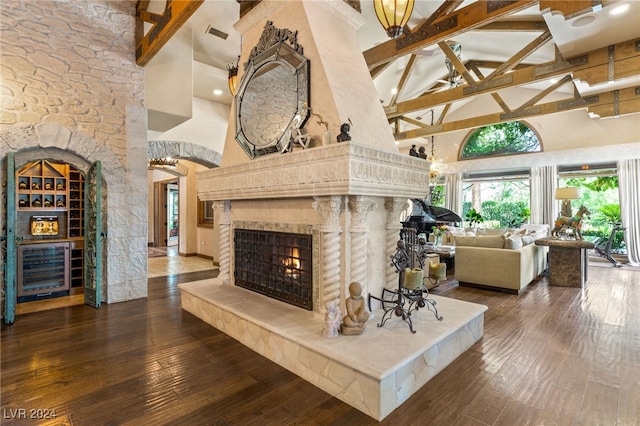 living room with high vaulted ceiling, beamed ceiling, and hardwood / wood-style floors