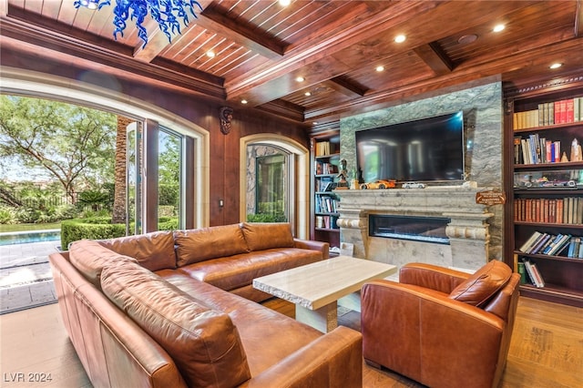 living room with light hardwood / wood-style floors, beamed ceiling, built in shelves, wood ceiling, and coffered ceiling