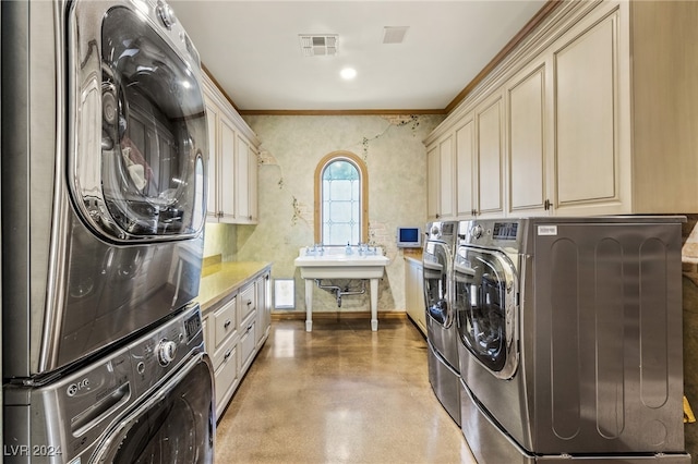 washroom with cabinets, sink, separate washer and dryer, and crown molding