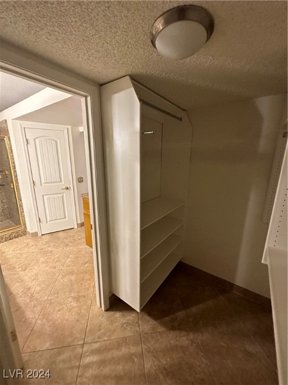 spacious closet featuring light tile patterned floors