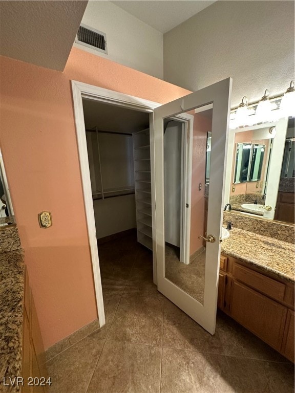 bathroom with tile patterned flooring and vanity