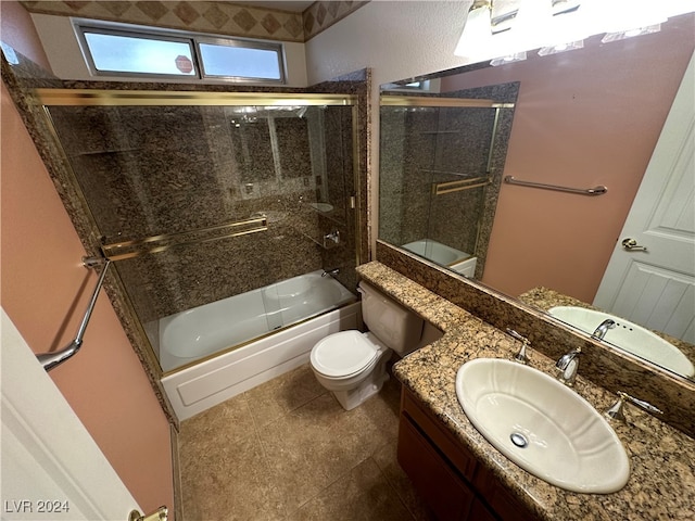 full bathroom with tile patterned flooring, vanity, toilet, and enclosed tub / shower combo