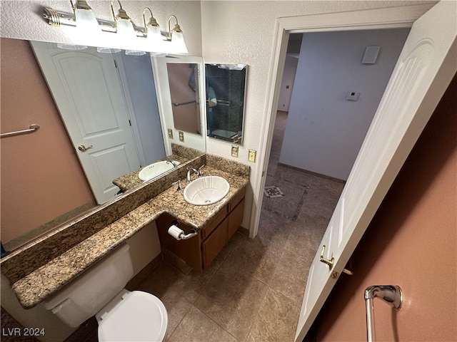 bathroom featuring tile patterned floors, vanity, and toilet