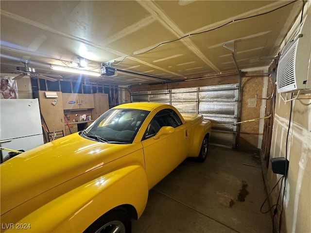 garage featuring white refrigerator, a garage door opener, and ceiling fan