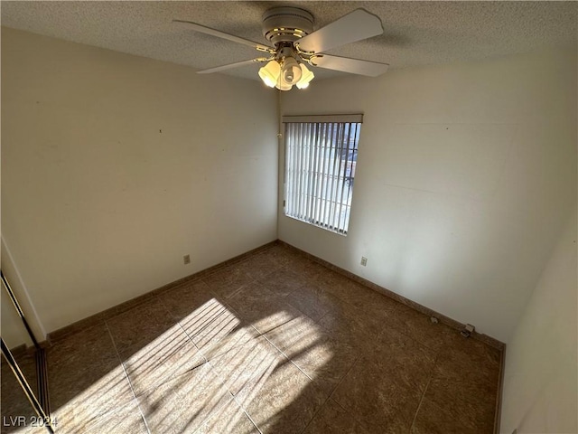 3218 Ocotillo Dr, Laughlin, NV 89029 - tiled spare room with ceiling fan and a textured ceiling