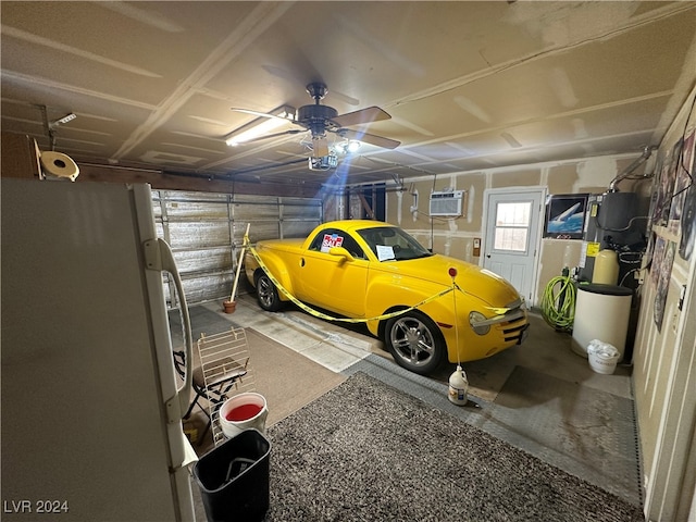 garage with a wall mounted air conditioner, white refrigerator, a garage door opener, and ceiling fan