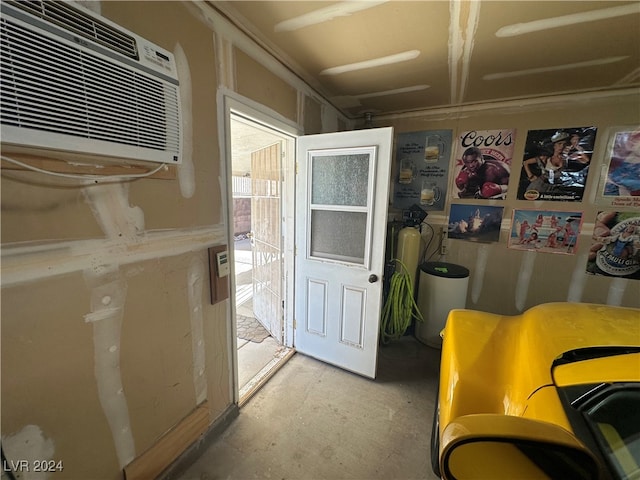 interior space with concrete floors and a wall mounted AC