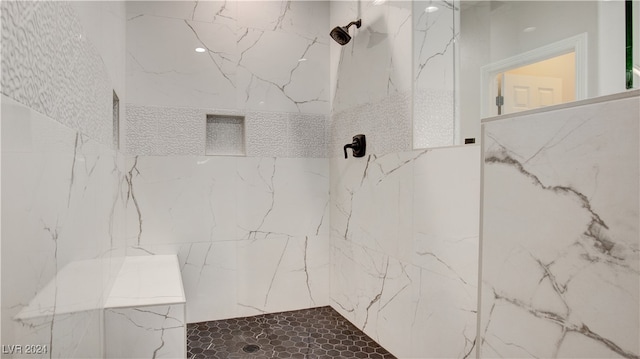 bathroom with a tile shower