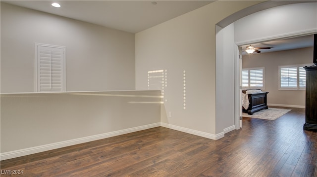 empty room with dark hardwood / wood-style flooring and ceiling fan