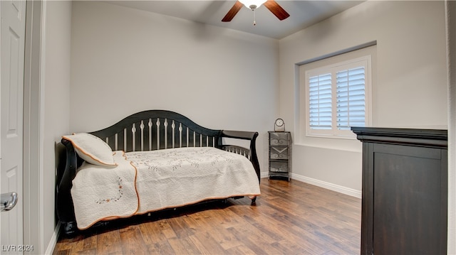 bedroom with dark hardwood / wood-style floors and ceiling fan