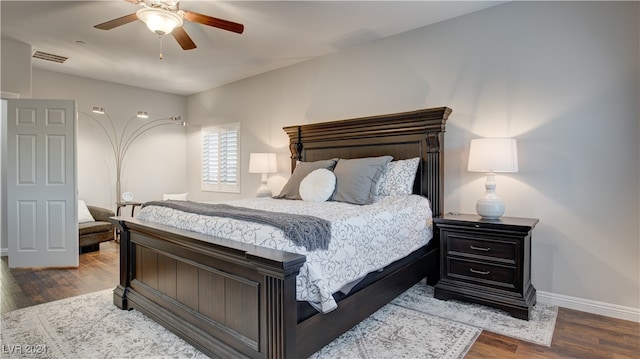 bedroom with ceiling fan and dark hardwood / wood-style floors