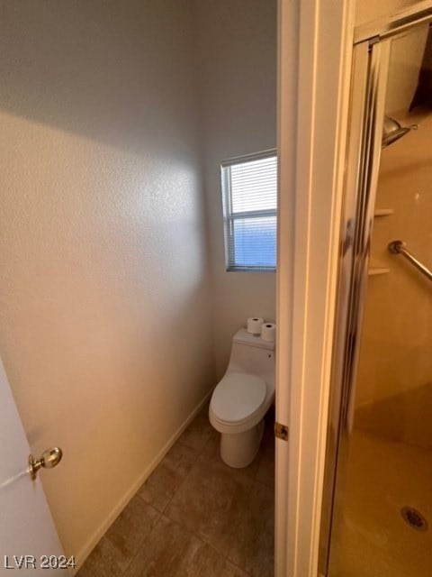 bathroom with toilet and walk in shower