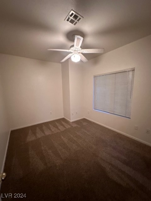 carpeted spare room featuring ceiling fan