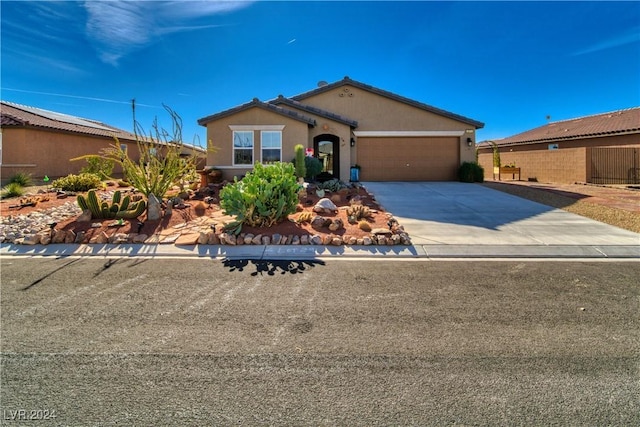 view of front facade with an attached garage, concrete driveway, and stucco siding