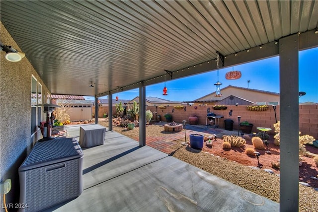 view of patio with an outdoor fire pit and a fenced backyard