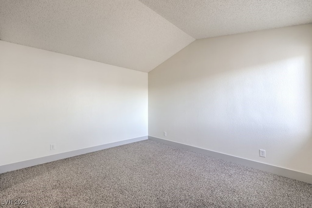 carpeted spare room with lofted ceiling and a textured ceiling