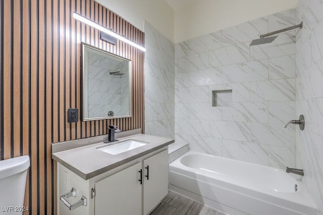 full bathroom featuring vanity, toilet, and tiled shower / bath combo