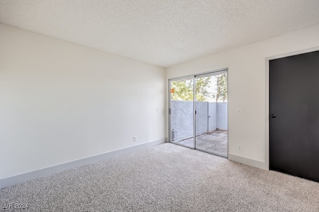 unfurnished bedroom with light carpet, a textured ceiling, and access to outside